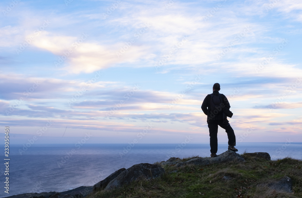 Hiker on top of Mount Jaizkibel with the sea in the background, Euskadi