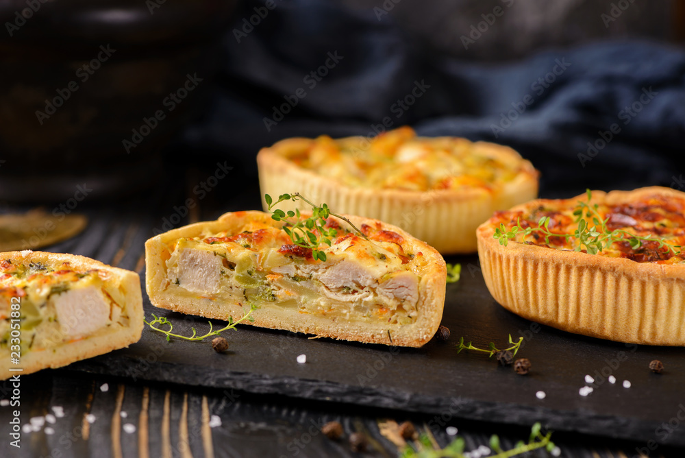 Meat mini pie on the wooden board on table background, closeup with copy space, rustic style