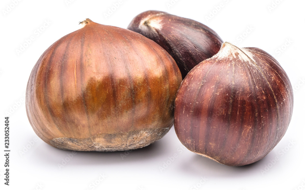 Fototapeta premium Roasted chestnuts served in chestnut pan on an old table