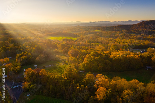 Aerial view of golden hour sunset in Georgia Mountains with sun rays