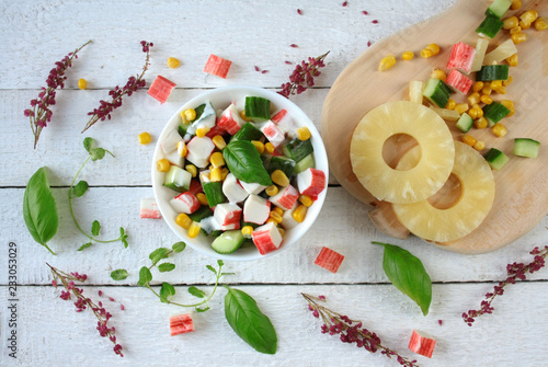 Obraz na płótnie Light salad with crab sticks, pineapple, cucumber and corn