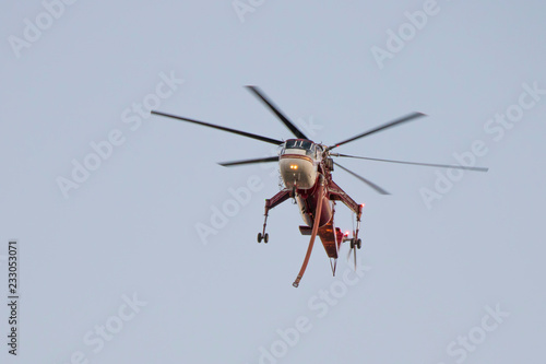 Water Dropping Helicopter in Flight over California Woolsey Fire