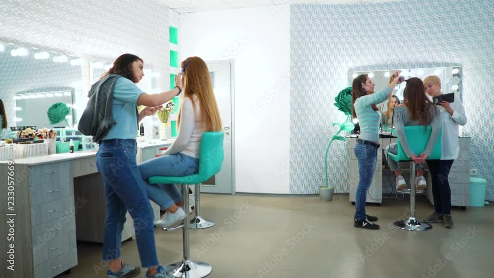 beauty shop review. makeup and haircut specialists prepare model girls for a fashion show. people, cosmetics, hairstyle, care, lifestyle, style concept