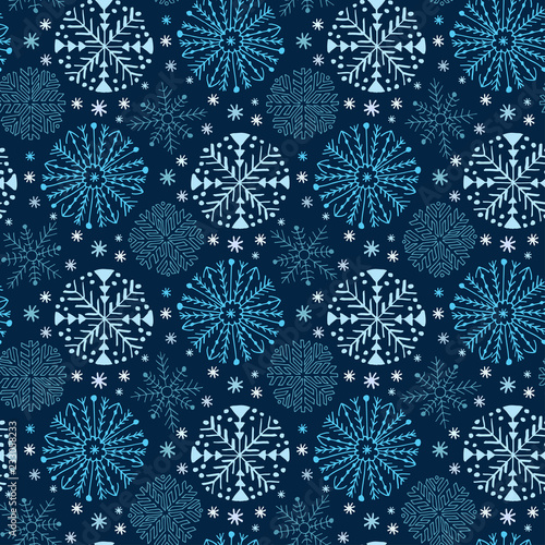 Christmas seamless pattern with snowflakes. Blue wrapping paper. Textile design, interior decor and New Year pattern.