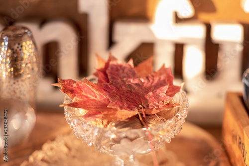 Bright colored maple leaves in crystal dish for Thanksgiving buffet