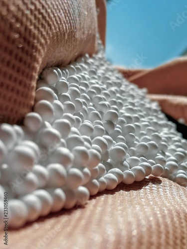 zoomed white expanded polystyrene pellets for production plastic bags.Polystyrene pellets on bright background.
