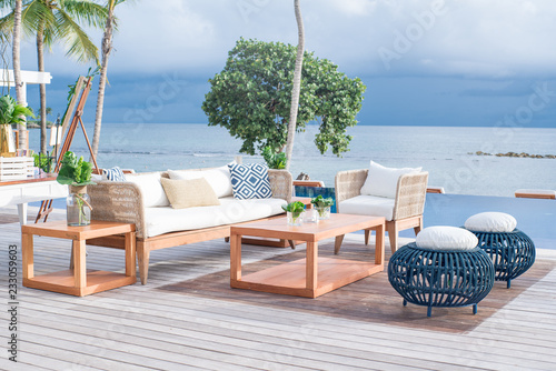 Exterior white couches on ocean front pool deck