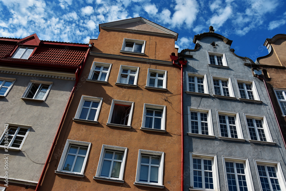 Beautiful view of Main Town of Gdansk , Poland, with ornate houses and amazing white clouds on a blue sky.