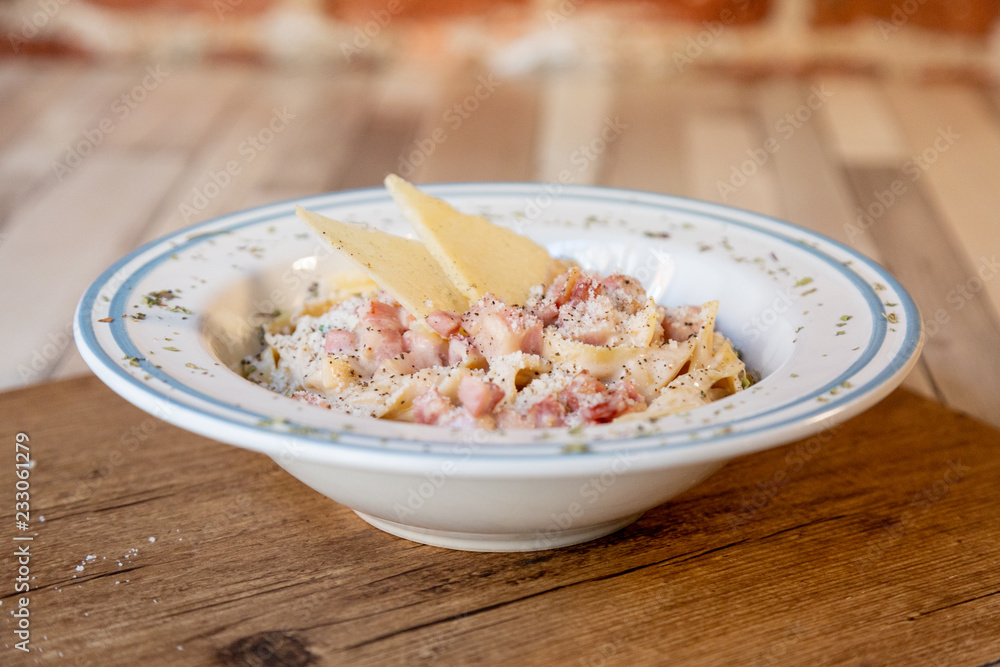 Carbonara spaghetti plate on a wooden table Carbonara spaghetti plate on a wooden table
