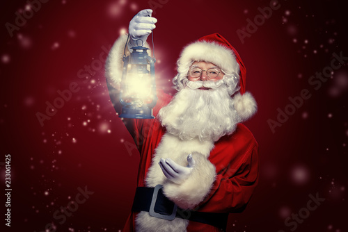 santa claus is holding lantern photo