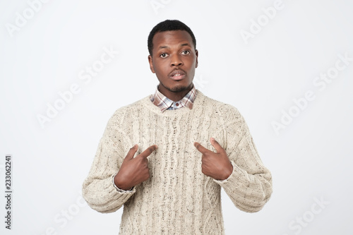 Фотография Young african man pointing at himself, making excuses or verbally defending,