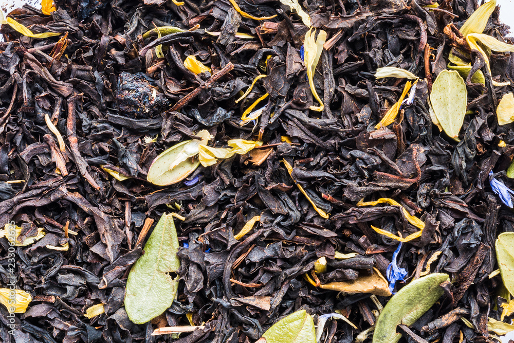 texture of black herbal tea with berries and leaves of blueberries and cranberries, closeup drink abstraction background texture of black herbal tea with berries and leaves of blueberries and cranberries, closeup drink abstraction background