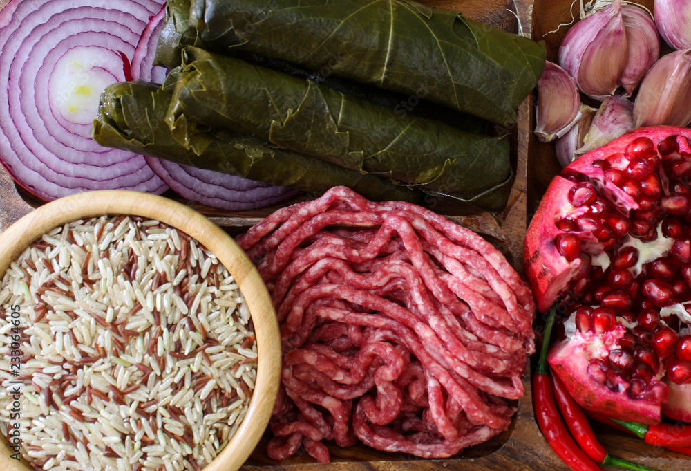 Fototapeta premium Raw ingredients for cooking dolma. Grape leaves, beef and pomegranate
