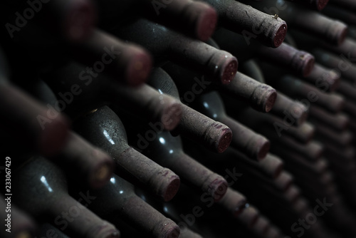 Old red wine bottles in dark cellar