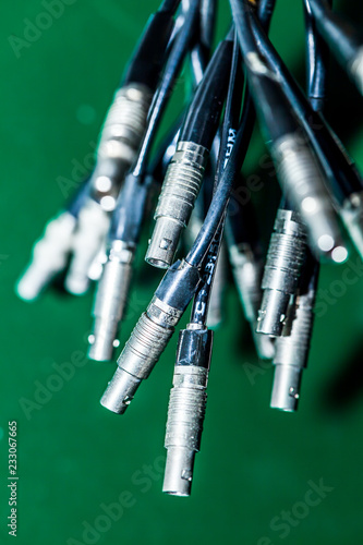 Miniature multi-pin connectors of female type on green background. photo