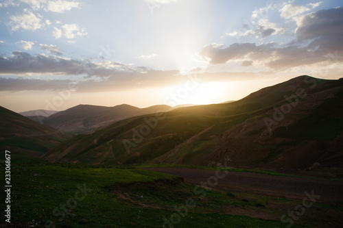 Landscape and nature around Ardabil Province, Iran. One stop during a roadtrip in Iran. Big clouds came over the mountain range. Adventure atmosphere so much clouds. photo