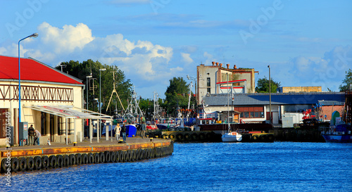 Ustka, Pomerania, Poland - Ustka seaport peers and ships and the Baltic Sea shoreline photo