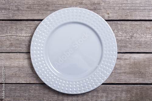 Empty gray plate on wooden table