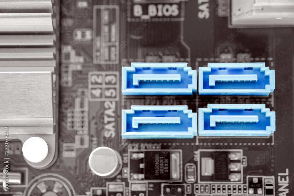 Blue color 4x SATA-II port in desktop PC motherboard on black and white  color filter, SATA-II is a port for hard disk connectivity, close-up and  selective focus by macro lens Stock Photo