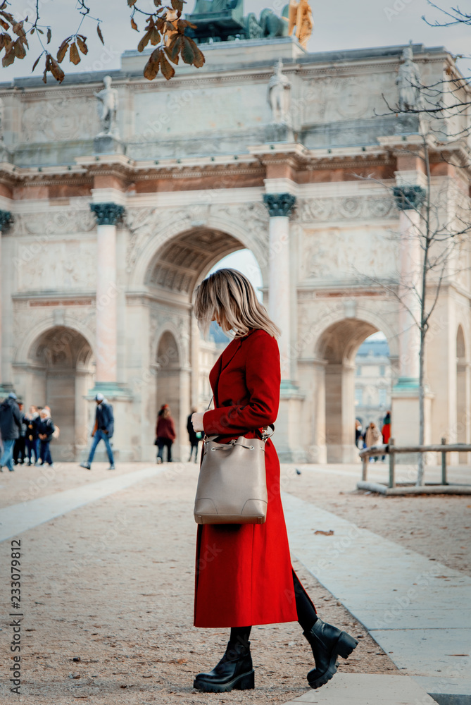 Style redhead girl in red coat and bag on parisian street in autumn season time Style redhead girl in red coat and bag on parisian street in autumn season time