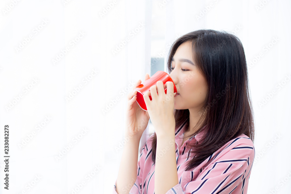 Beautiful of portrait young asian woman with drink a cup of coffee standing curtain window background in bedroom, girl relax in morning at home, lifestyle concept. Beautiful of portrait young asian woman with drink a cup of coffee standing curtain window background in bedroom, girl relax in morning at home, lifestyle concept.