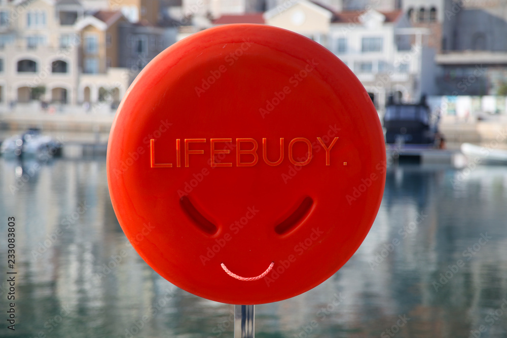 Red lifebuoy outdoors stand against nautical background