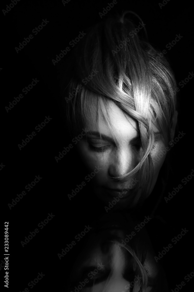 Portrait of a woman looking in the mirror Portrait of a woman looking in the mirror