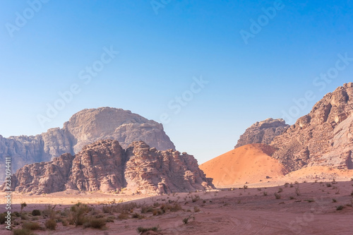 Red mountains of Wadi Rum desert in Jordan. Wadi Rum also known as The Valley of the Moon is a valley cut into the sandstone and granite rock in southern Jordan to the east of Aqaba