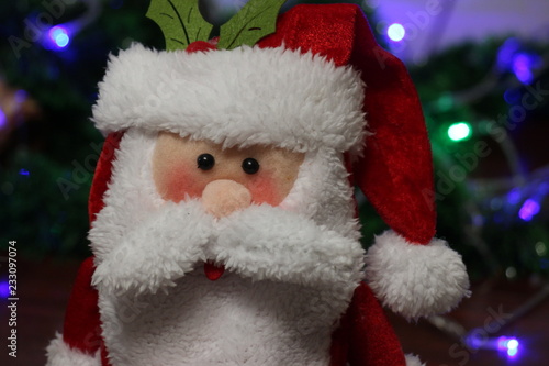 Obraz na plátne Toy santa clause with lights on the background