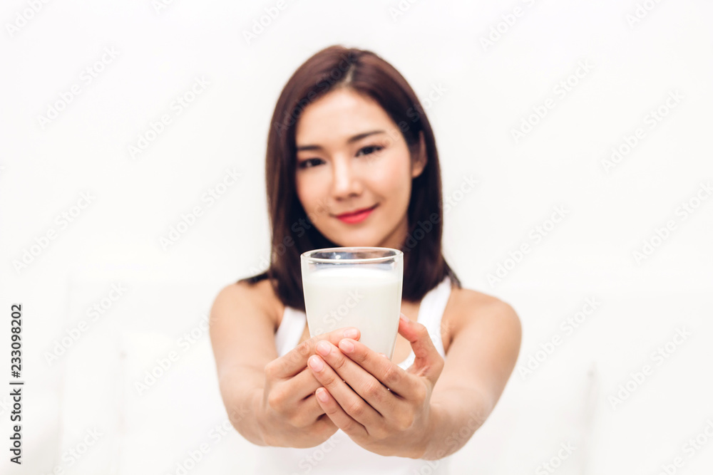 Woman hands holding glass of fresh milk Woman hands holding glass of fresh milk