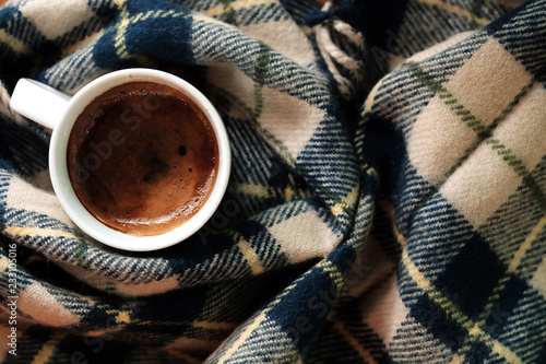 Hot black coffee or Americano coffee with blue wool Scarf background and have some space for write wording 