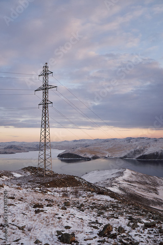 Power tower against clouds and blue sky on Baikal lake © Виталий Кравченко