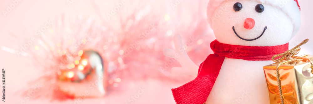 Merry Christmas, New Year, snowman gifts in golden boxes and a golden heart on a background of pink and yellow bokeh.