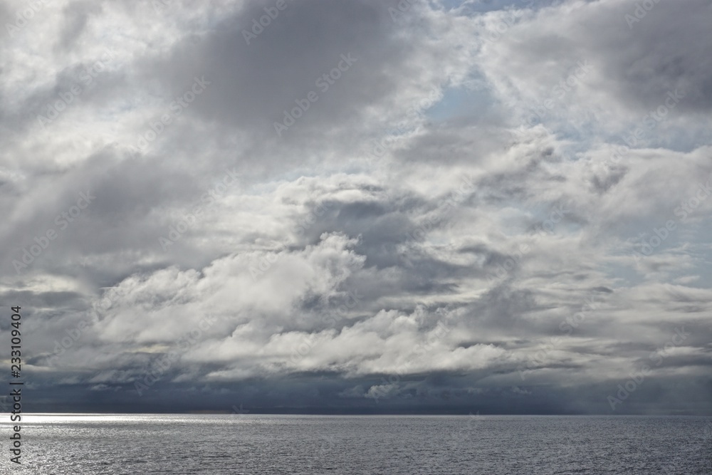 The sun pierces through gathering storm clouds over the Gulf of Alaska. The sun pierces through gathering storm clouds over the Gulf of Alaska.