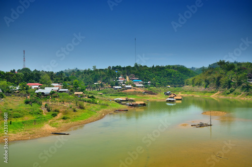 bridge over the river in the middle of the mountains. the Sagklaburi Kanchanaburi, Thailand photo