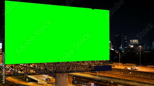 Green screen of advertising billboard on expressway during the twilight with city background in Bangkok, Thailand. photo