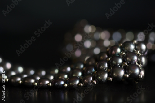 Black pearl necklace on a dark background close up