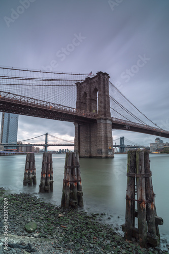 View on Manhattan bridge and Brooklyn bridge from the pier at sunset,long eposure photo photo