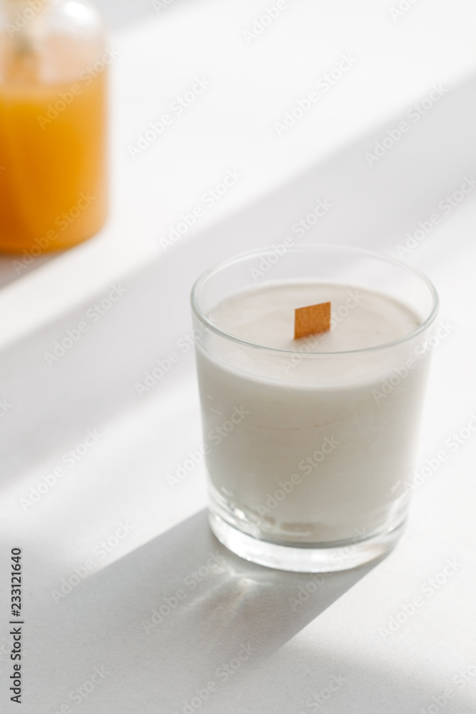 Organic scented soy candle on white. Loft interior decor, minimalism concept. Closeup, copy space for text Organic scented soy candle on white. Loft interior decor, minimalism concept. Closeup, copy space for text