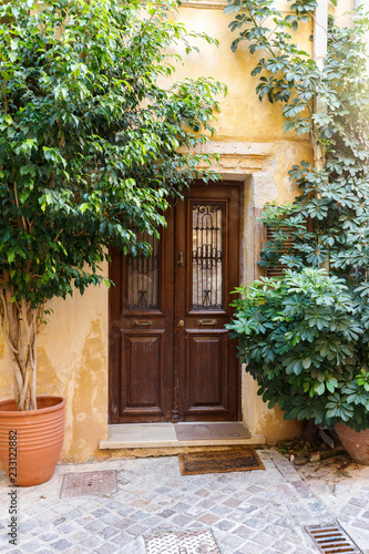 national flavor, ancient Greek streets on the island of Crete. Old houses, doors, Windows, potted plants and small outdoor cafes.