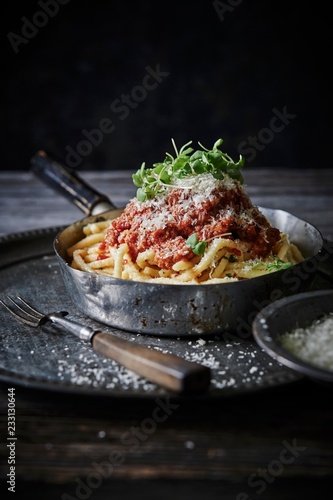 Linguine and meatballs garnished with cheese and herb in saucepan photo