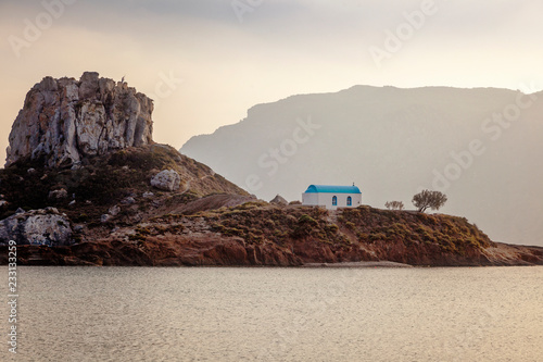 Kos island, Greece, coast view of Kefalos village, island of Kastri and an orthodox temple at sunset photo