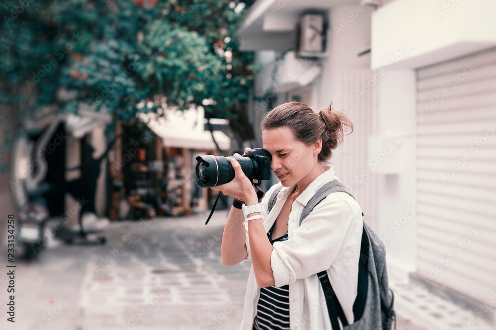 Beautiful young woman with a camera in her hands, professional at work Beautiful young woman with a camera in her hands, professional at work