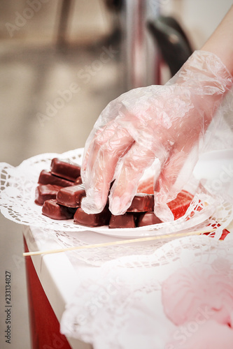woman lays homemade confectionery on the shop window