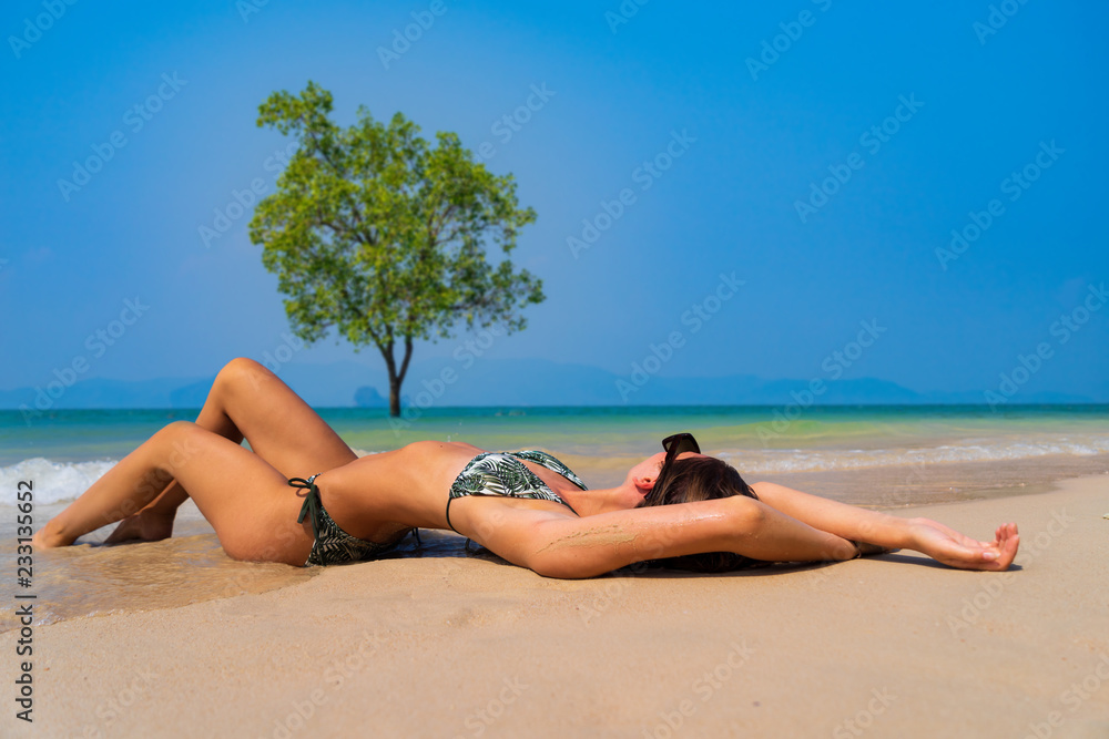Cute woman relaxing on the summer beach. Cute woman relaxing on the summer beach.