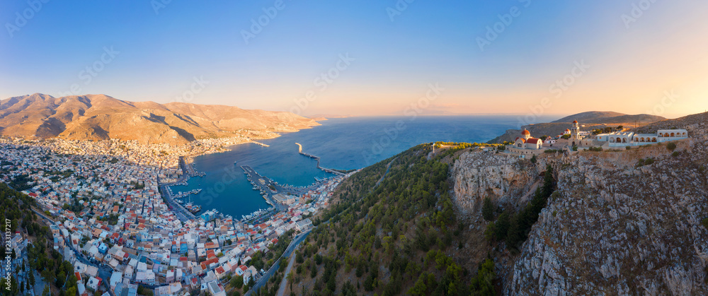 View of Pothia, capital of Kalymnos, Greece, and Monastery of Agios Savvas located on top of hill, on left