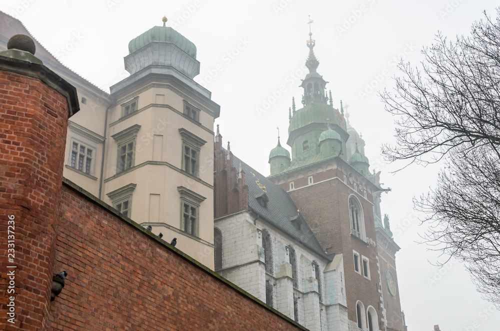 Wawel Castle in the morning fog in Krakow, Poland Wawel Castle in the morning fog in Krakow, Poland