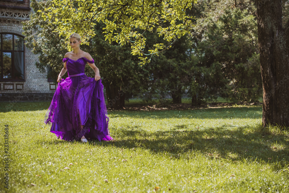 Vintage clothes concept, girl in evening purple dress in garden