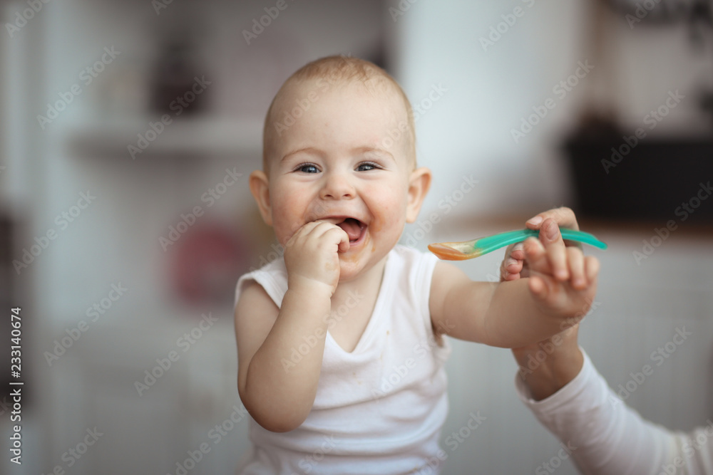 happy baby with an appetite stretching for spoon happy baby with an appetite stretching for spoon