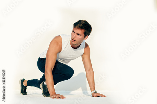Young caucasian man working out isolated on white